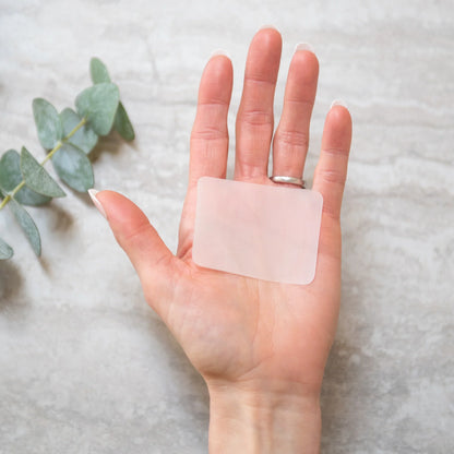 Hand holding a single hand soap sheet; compact, eco-friendly, and perfect for travel and sustainable, chemical-free cleanliness.