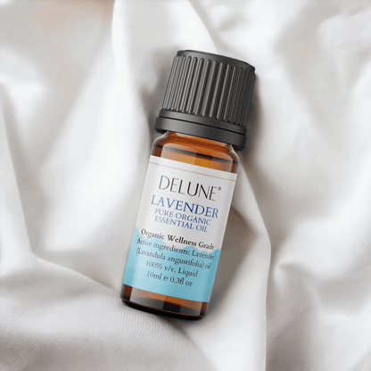 Glass bottle of Delune Lavender Organic Wellness Grade Essential Oil, 10ml, with a calming aroma, on a soft white fabric.