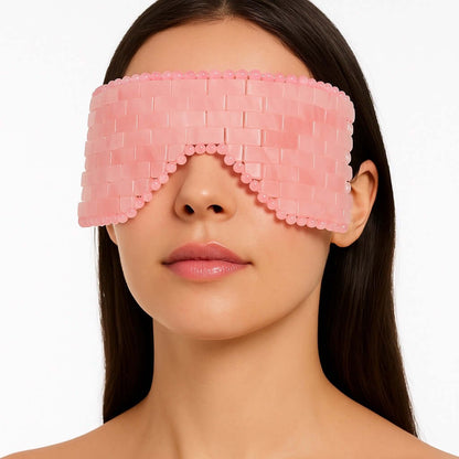 Woman wearing Rose Quartz Eye Mask for skincare relaxation, crafted from hand-polished stone, promoting self-love and wellness.